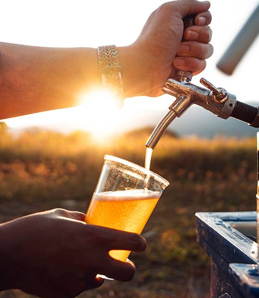 Close-up uf hands toasting in beer,Pouring a beer